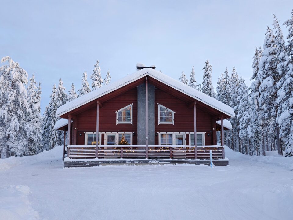 Chalet Nulkka, a dark-red log cabin under deep snow in Levi, Finnish Lapland