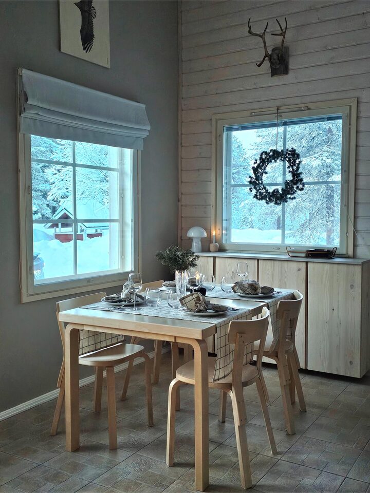 Dining table for six by the window with snowy trees outside