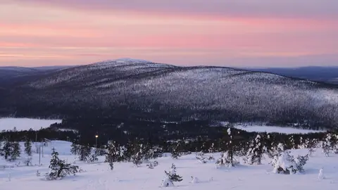 Pink winter sunset over the snow-covered fells of Levi