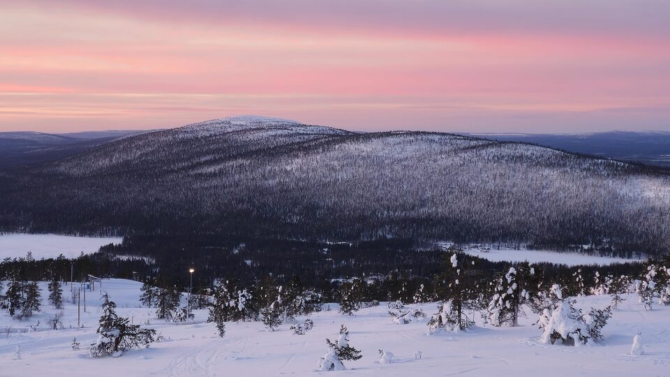 Pink winter sunset over the snow-covered fells of Levi