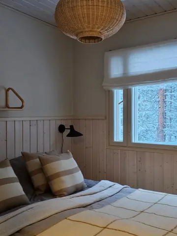 Ground-floor bedroom with a double bed and a view to the forest