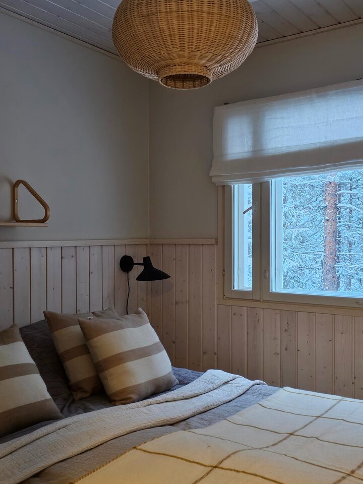 Ground-floor bedroom with a double bed and a view to the forest