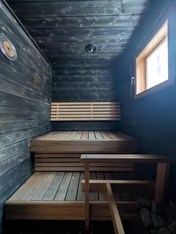 Sauna benches and stove at Chalet Nulkka