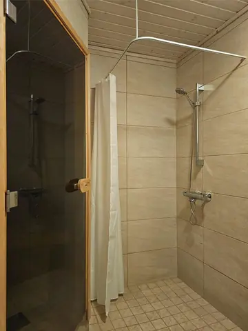 Shower room next to the sauna with a washing machine and dryer