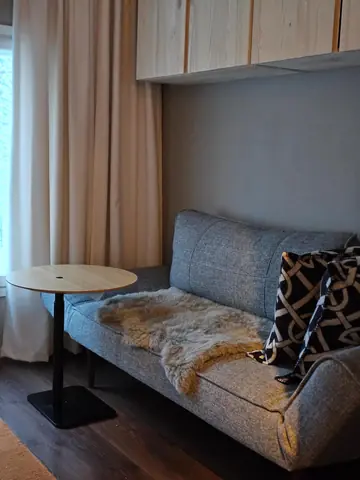 Upstairs lounge with a sofa bed and a small table