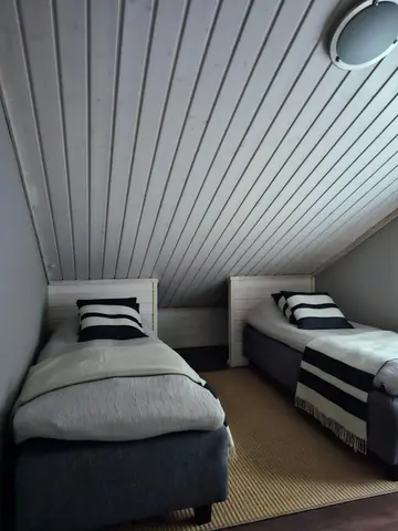 Upstairs bedroom with two single beds under the sloping ceiling